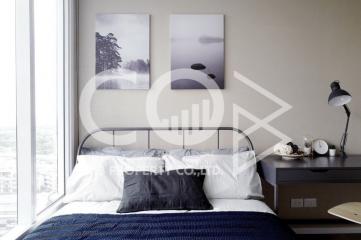 Modern bedroom with large window and wall art