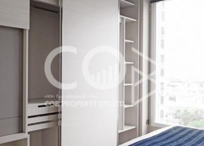 Modern bedroom with built-in wardrobe and city view