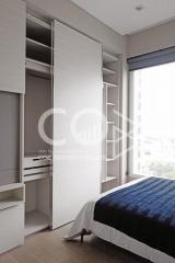 Modern bedroom with built-in wardrobe and city view