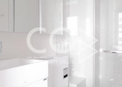 Modern bathroom with white fixtures and glass shower partition