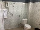 Bathroom with white fixtures, shower, and patterned tile walls