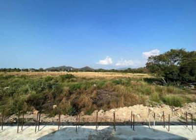 Expansive outdoor view of a potential construction site with foundation work started