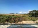 Expansive outdoor view of a potential construction site with foundation work started