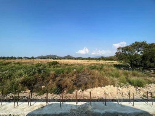 Expansive outdoor view of a potential construction site with foundation work started