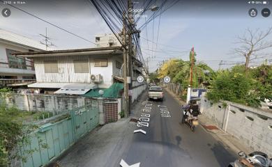 Residential street view with houses and a motorcyclist