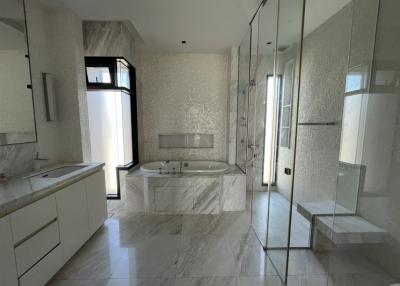 Spacious modern bathroom with marble finish and a bathtub