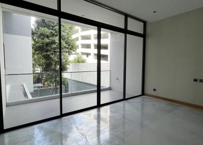 Spacious living room with large windows and marble flooring