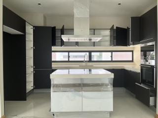 Modern kitchen with central island and built-in appliances