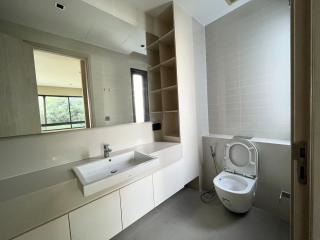 Modern bathroom with a large mirror and ample lighting