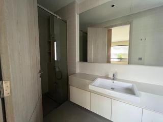 Modern bathroom with a walk-in shower and a large mirror