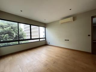 Spacious living room with large windows and natural light