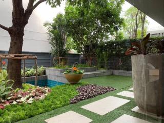 Enclosed home garden with artificial grass and vibrant greenery
