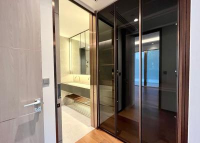 Modern bathroom with glass shower enclosure and wooden accents