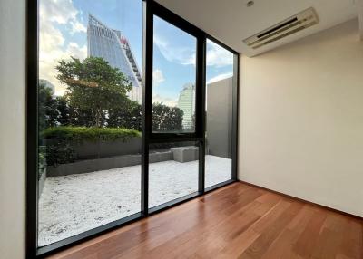 Modern bedroom with large windows and city view