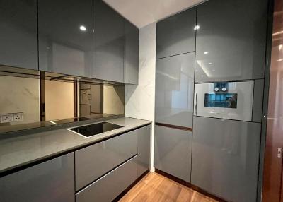 Modern kitchen with gray cabinetry and built-in appliances