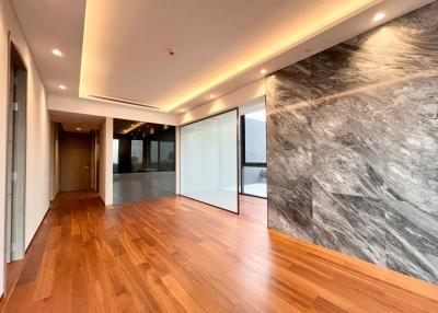 Modern interior with hardwood floors and marble wall