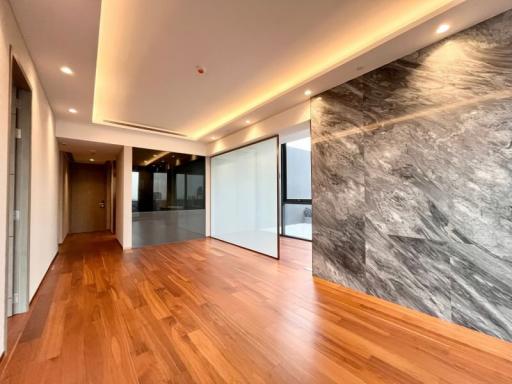 Modern interior with hardwood floors and marble wall