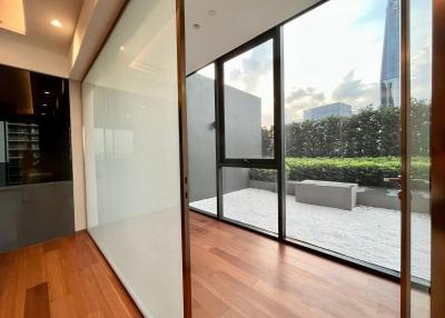 Modern living area with large glass windows and wooden flooring