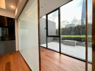 Modern living area with large glass windows and wooden flooring