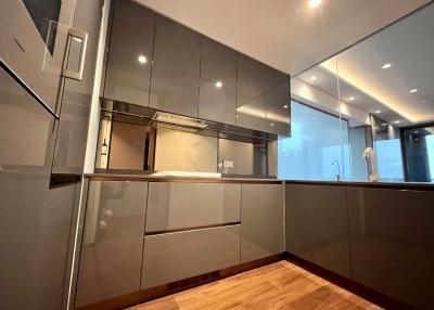 Modern kitchen with wooden flooring and grey cabinets