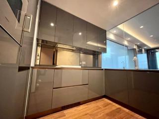 Modern kitchen with wooden flooring and grey cabinets