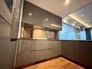 Modern kitchen with wooden flooring and grey cabinets