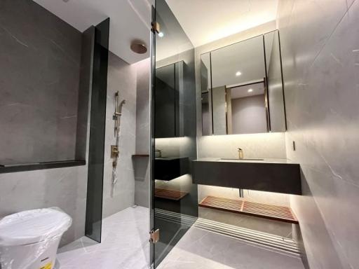 Modern bathroom interior with marble tiles and glass shower partition