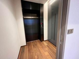 Entrance hall with elevator and wooden flooring