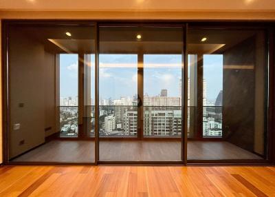 Spacious living room with large windows and city view