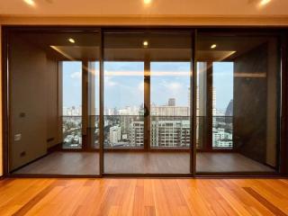 Spacious living room with large windows and city view