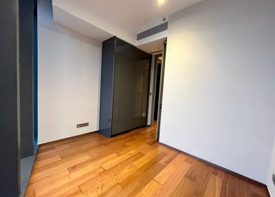 Empty bedroom with hardwood floors and white walls