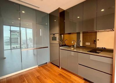 Modern kitchen with wooden floor and glass partition