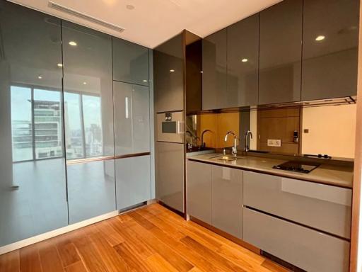 Modern kitchen with wooden floor and glass partition