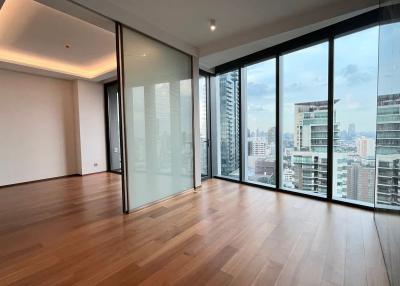 Spacious empty room with large window walls and panoramic city view