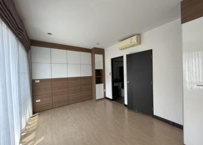 Spacious bedroom with large wardrobe and air conditioning unit
