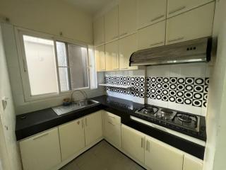 Modern kitchen with stainless steel appliances and patterned backsplash