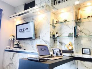 Modern office interior with marble walls, a desk with computer, and decorative elements