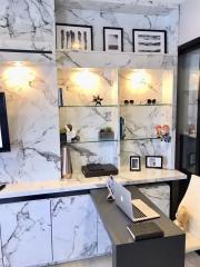 Elegant home office with marble walls and modern decor