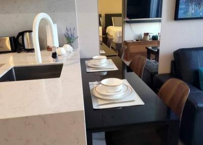 Modern kitchen with dining area and view into the living room