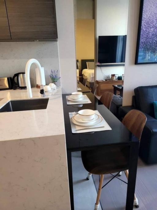 Modern kitchen with dining area and view into the living room