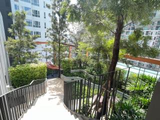 Spacious balcony with greenery and urban views