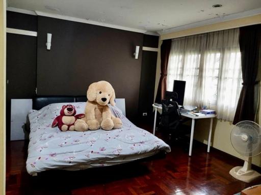 Cozy bedroom with a large bed and stuffed animals