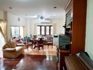 Spacious living room with natural light and hardwood floors