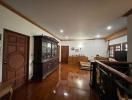 Spacious and well-lit living room with classic wooden furniture