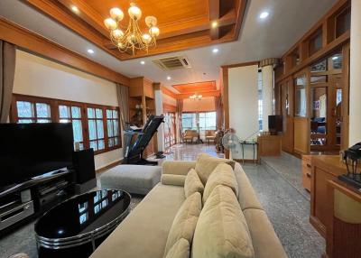 Spacious living room with classic wood trim and grand piano