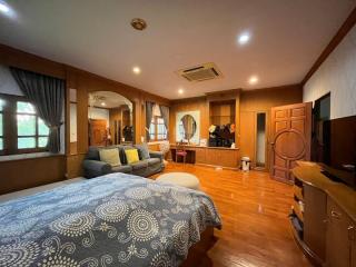 Spacious bedroom with wooden furniture and flooring