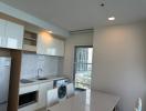 Modern kitchen with integrated appliances and ample natural light