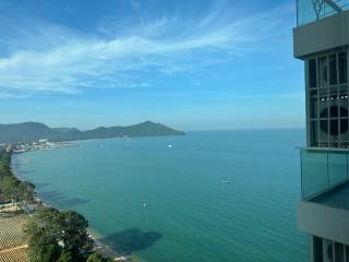 Coastal view from a high-rise apartment showing ocean and skyline