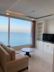 Modern living room with ocean view, natural light, and contemporary furniture