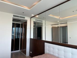 Modern bedroom interior with large mirrored wardrobe
